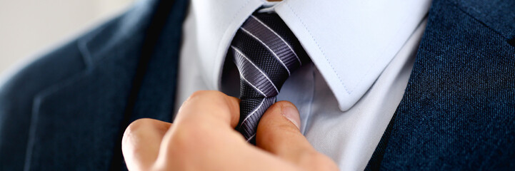 Male arm in blue suit set tie closeup