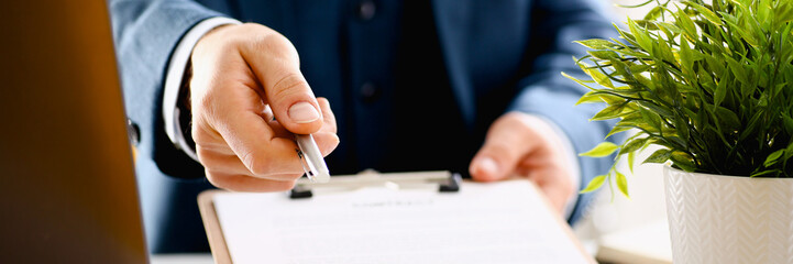 Male arm in suit offer contract form on clipboard
