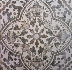 Gray ceramic tile with floral pattern for wall decoration. Concrete stone surface background. Vintage texture for design interior project.