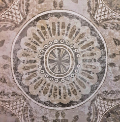 Gray ceramic tile with floral pattern for wall decoration. Concrete stone surface background. Vintage texture for design interior project.