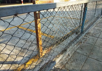 Rusty iron wall fencing on the side of the road