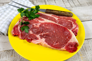 raw beef ribeye on a plate