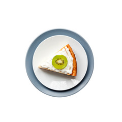 Homemade cottage cheese cake with kiwi fruit and cream on a plate isolated on white background with clipping path