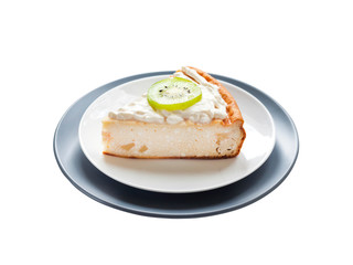 Homemade cottage cheese cake with kiwi fruit and cream on a plate