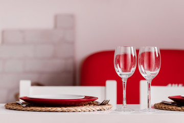 Romantic Dinner at home on the kitchen. Place setting for Valentine's Day or dinner date celebration wedding.