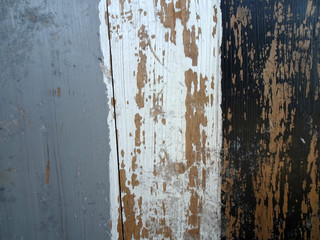 Rustic wood plank painted with three colors: gray, white and black