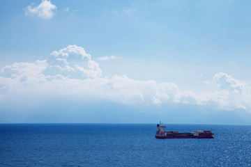 Cargo ship with containers in deep blue sea