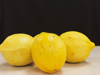 Yellow lemon fruit on a black background