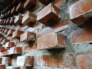 Close up look wall made of red brick wall with unique composition