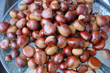 autumn chestnuts. raw chestnuts chestnuts on a glass table