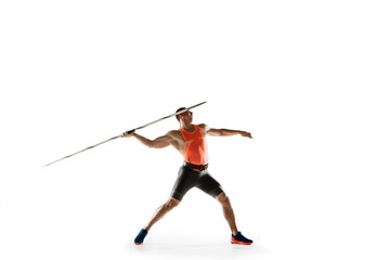 Male athlete practicing in throwing javelin isolated on white studio background. Professional...