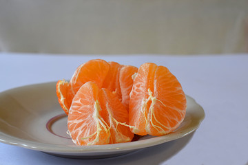 Purified mandarin on the light surface of the table.