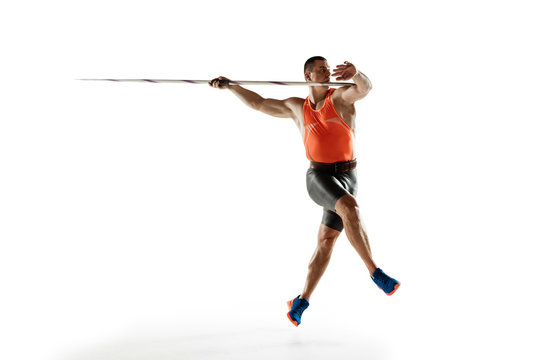 Male athlete practicing in throwing javelin isolated on white studio background. Professional sportsman training in motion, action. Concept of healthy lifestyle, movement, activity. Copyspace.