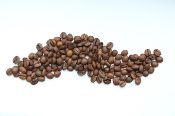 Wave symbol made from roasted coffee beans on the white background. Blend of 70% arabica and 30% robusta is used for this photo. Food Symbol Theme.