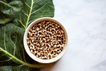 Overhead view of uncooked blackeye peas and collard greens
