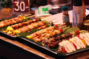 Thai street food at outdoor night market in Bangkok, Thailand.