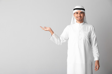 Handsome Arab man on light background