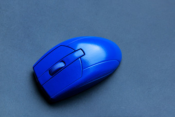 Blue PC mouse on grey background