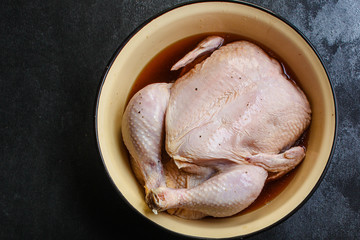 raw chicken in marinade (poultry, carcass meat) menu concept. food background. top view. copy space