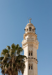 Fototapeta na wymiar A mosque with a minaret stands in the main square - Manger Square - in Bethlehem in Palestine