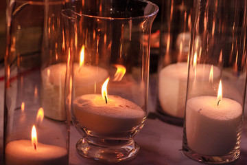cozy decor with candles burning in glass flasks