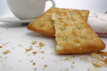 Cracker with coffee cup on white background