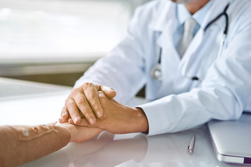 Doctor and patient are discussing something, just hands at the table