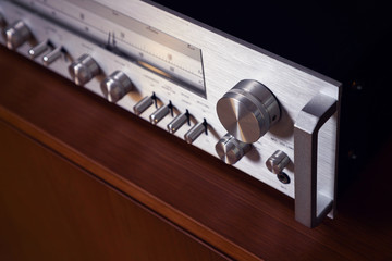 Fototapeta premium Vintage Stereo Receiver Standing on the Wooden Sideboard, Side View