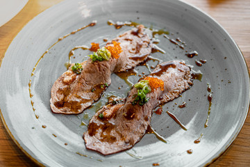 Sushi wagyu beef burned with teriyaki sauce on the grey dish 