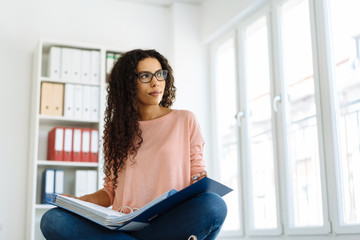 Young African woman sitting studying