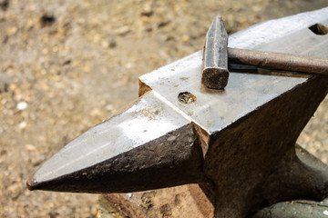 Anvil with a hammer in the workshop.