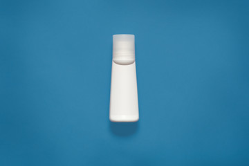 Mockup horizontal picture of white plastic bottle for liquids, cosmetic issues, situated in centre...