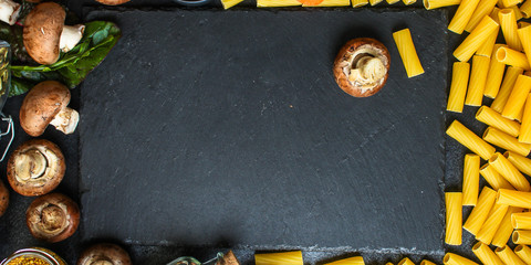 Obraz premium pasta Tortiglioni and ingredients for mushroom sauce (Italian main course Maccheroni, Rigatoni) menu concept. food background. top view. copy space