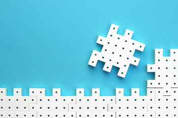 White puzzle pieces on the  turquoise background show cohesion, teamwork and agreement.