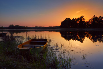 Boat by the lake, beautiful summer evening