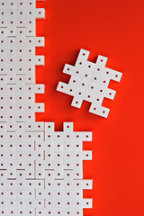 White puzzle pieces on the orange background show cohesion and agreement.