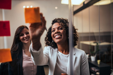 Close-up portrait of a happy entrepreneurs working with notes.