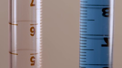 A test tube with a blue and red liquid - Powered by Adobe