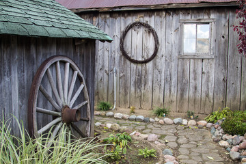 Obraz premium Country Garden Shed. Winding stone path among gardeners shed and outbuildings.