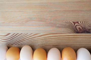 line of eggs laid on an old wooden table
