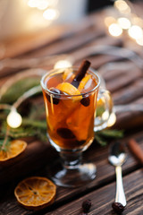 Winter hot tea with fruit, berries and spices in glass cup. 