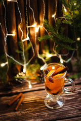 Winter hot tea with fruit, berries and spices in glass cup. 