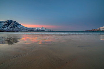 Amazing sunrise with amazing magenta color over sand beach. Tromso, Norway . Polar night. long shutter speed