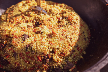 Rice pilaf in a cauldron at the stake