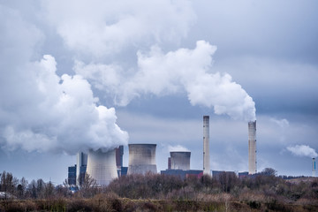 Environmental pollution with plumes of smoke from the chimneys of a power plant.