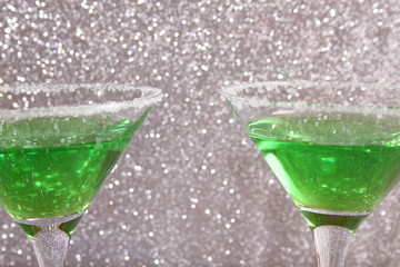 Two glasses with green drinks