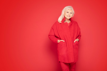 Fototapeta premium Senior lady in red fashionable clotes.