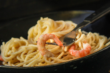 pasta shrimp (spaghetti cream sauce and seafood prawn) menu concept. food background. top view. copy space