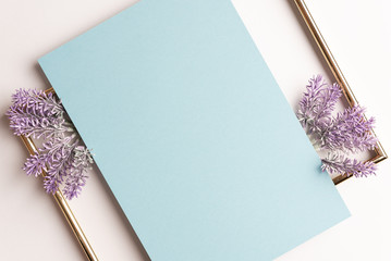 Lavender flowers ,card of blue paper and golden frame on a white background, template for design, floral background