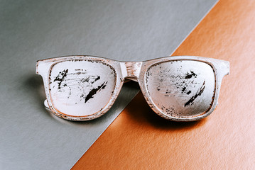 Summer glasses silver color with scratches on a gray copper paper geometric background